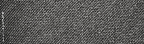 The texture of dark gray fabric is fluted in stripes.Background of dense gray fabric.