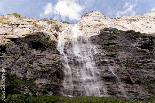 Scenic view on green mountings and sky in Lauterbrunnen Valley, Switzerland