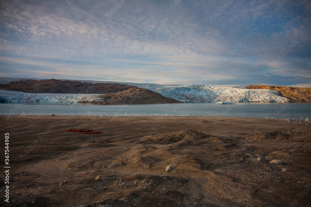 Kayak expedition between icebergs in Narsaq fiords, South West Greenland, Denmark Kayak expedition between icebergs in Narsaq fiords, South West Greenland, Denmark