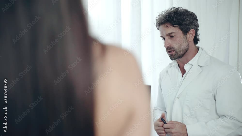 Female patient having appointment and consultation with orthopedist doctor in medical centre, concentrated physician in white lab coat staying in front of monitor and explaining results of X-ray image Female patient having appointment and consultation with orthopedist doctor in medical centre, concentrated physician in white lab coat staying in front of monitor and explaining results of X-ray image
