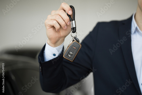 Car dealer with key close-up