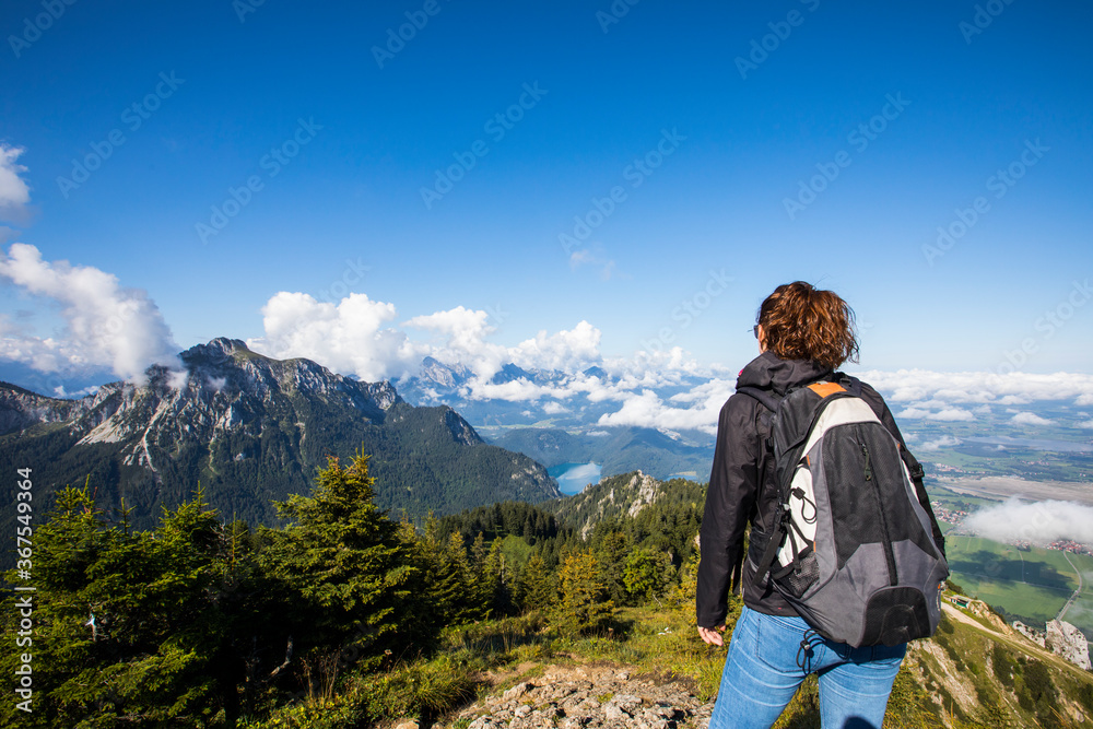 Girl and summer sunrise in Bavaria mountains, South Germany. Europe