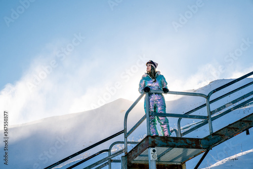 Beautiful asian woman enjoying and relaxing view with snow flake on snow mountain during winter in New Zealand.