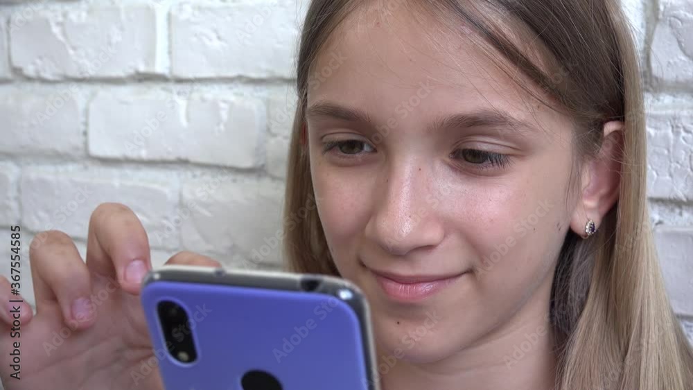 Kid Playing Smartphone Browsing Internet, Child using Smart Phone, Girl Writing Reading Messages Kid Playing Smartphone Browsing Internet, Child using Smart Phone, Girl Writing Reading Messages