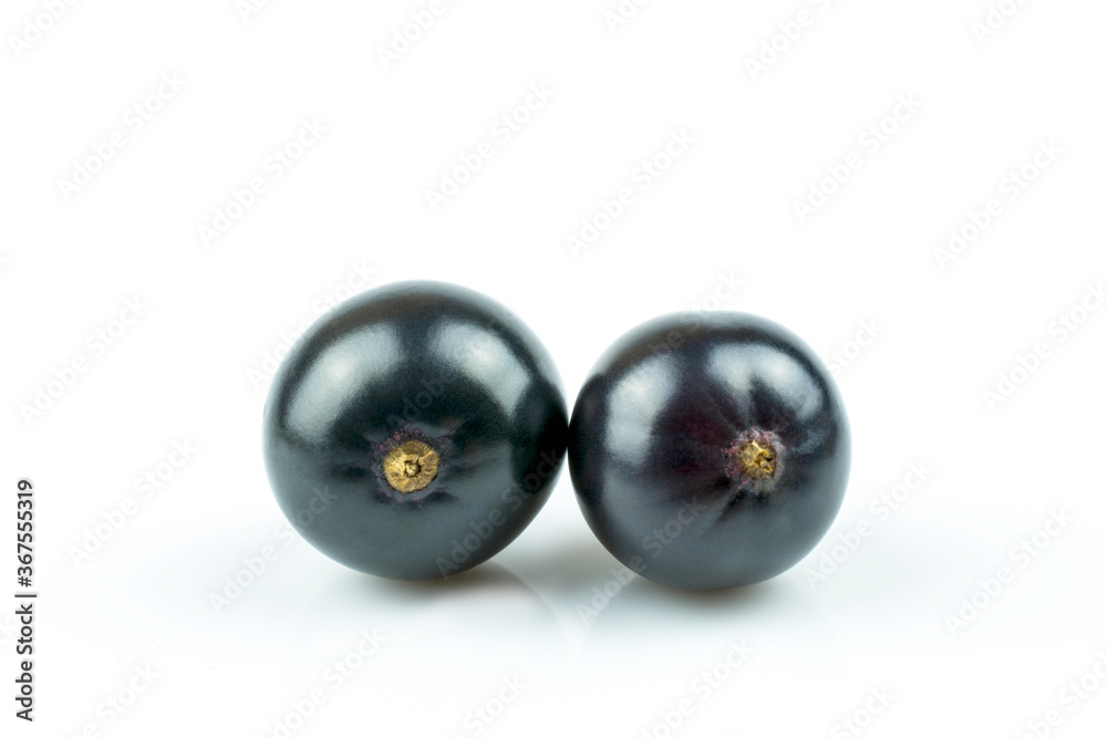 Two berries of black currant close-up isolated on a white background. Two berries of black currant close-up isolated on a white background.
