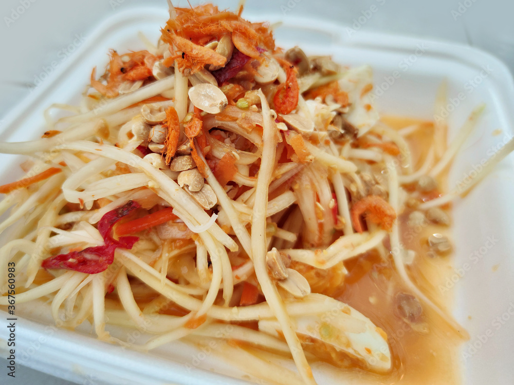 Close-up spicy Papaya salad dressing with carrots peanut dried shrimp and tomato, famous secret recipe of freshness thai eastern street food restaurant, food stylist backgrounds menu Close-up spicy Papaya salad dressing with carrots peanut dried shrimp and tomato, famous secret recipe of freshness thai eastern street food restaurant, food stylist backgrounds menu