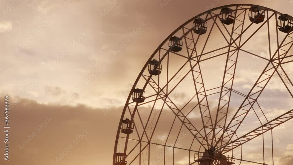 Ferris wheel with light rotates on sunset sky background Ferris wheel with light rotates on sunset sky background