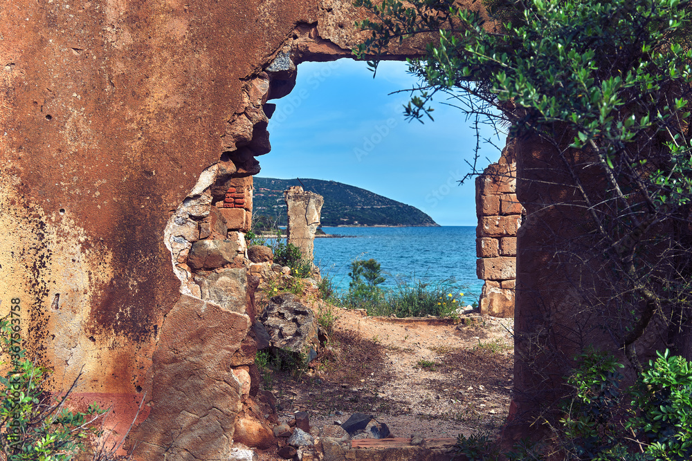 panorama of the sea seen through a ruined house