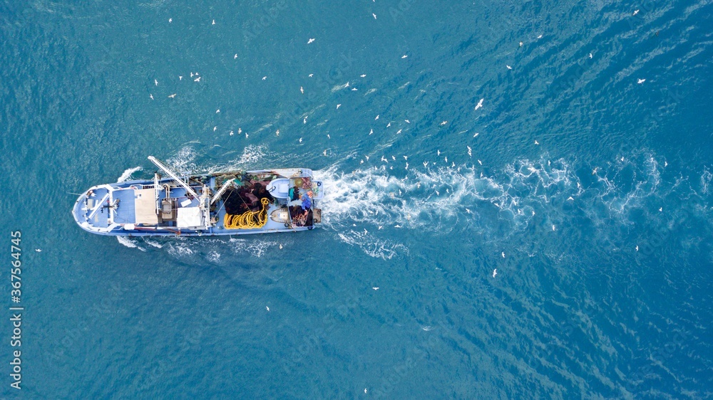 Naklejka premium aerial view of the fishing boat at the sea
