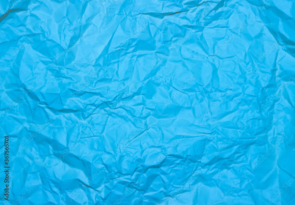 Crumpled blue background. Wrinkled blue texture.