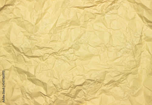 Crumpled yellow background. Wrinkled yellow texture.