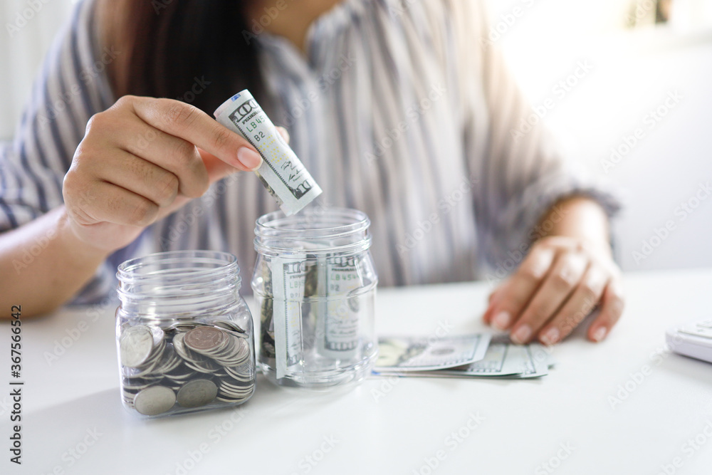 Fototapeta premium Saving money concept Financial woman hand stack coins money banknotes growing business. Saving money