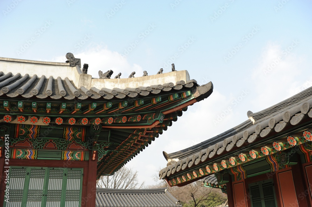 Roofs of Gyeongbokgung Palace under the sunlight and a blue cloudy sky in South Korea Roofs of Gyeongbokgung Palace under the sunlight and a blue cloudy sky in South Korea