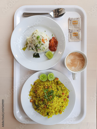 Poha and Upma plated on a wooden table