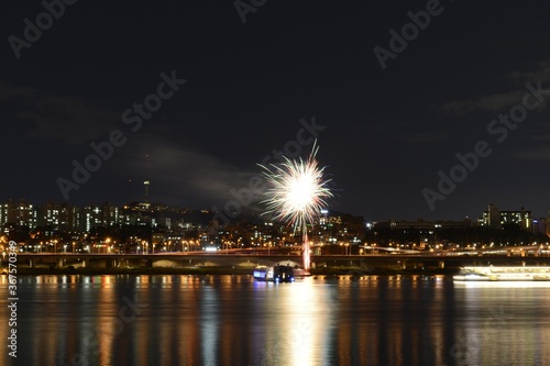 Beautiful scenery of fireworks over an illuminated cityscape at Han-River in Seoul, South Korea