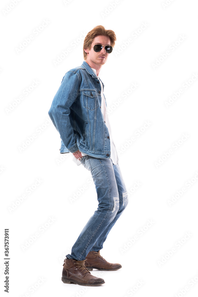 Handsome young red hair male fashion model in jeans posing and bending backwards. Full body length isolated on white background. Handsome young red hair male fashion model in jeans posing and bending backwards. Full body length isolated on white background.