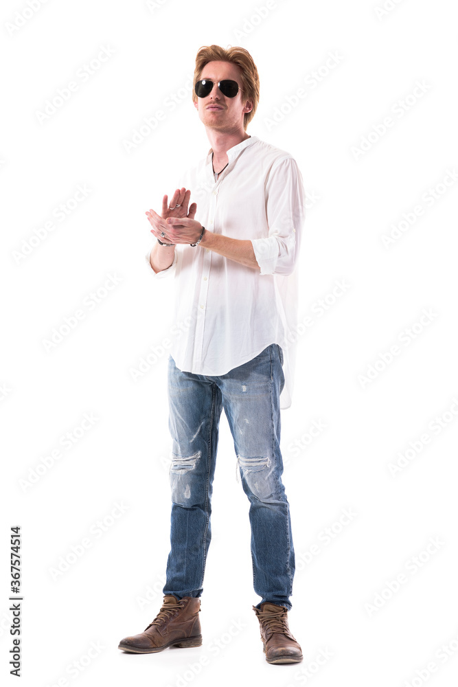 Confident stylish young man clapping hands applauding for endorsement. Full body length isolated on white background. Confident stylish young man clapping hands applauding for endorsement. Full body length isolated on white background.