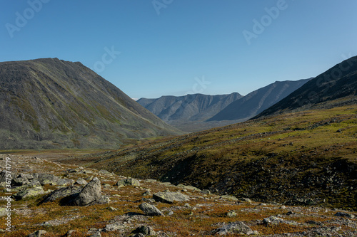 The concept of outdoor activities in the mountains. Minimalist mountain landscape. Atmospheric view. The majestic nature of the Circumpolar Urals.