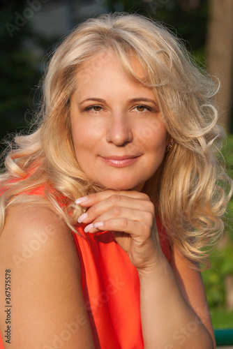 Portrait of a blonde women in a red summer dress