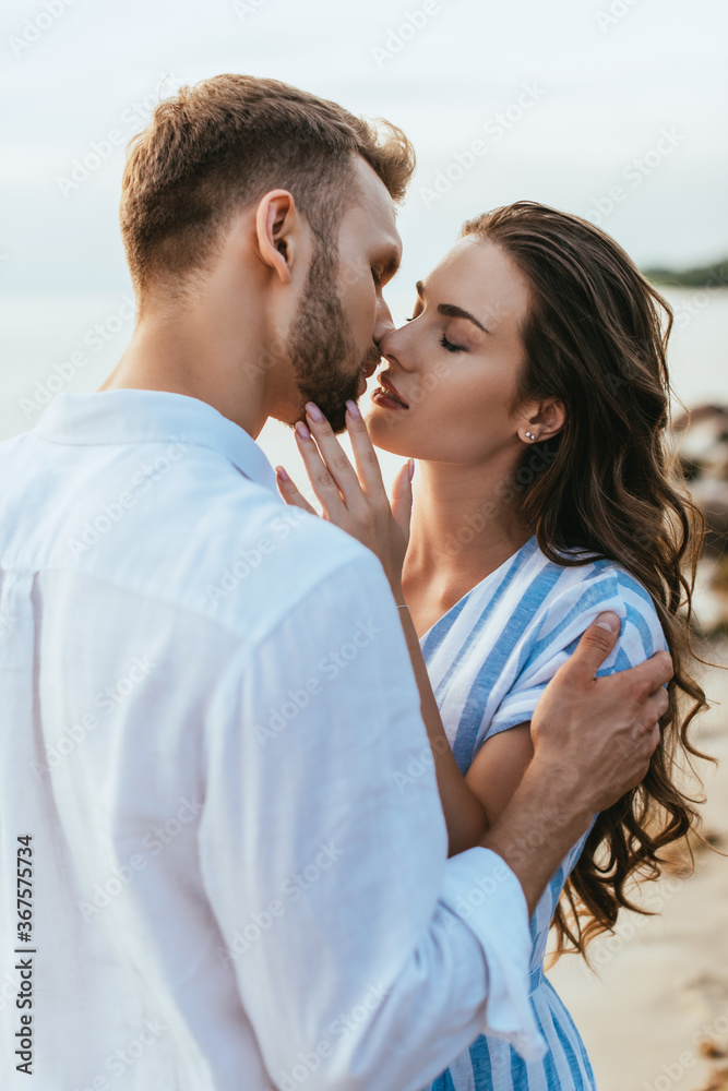 Fototapeta premium beautiful woman with closed eyes kissing with bearded man