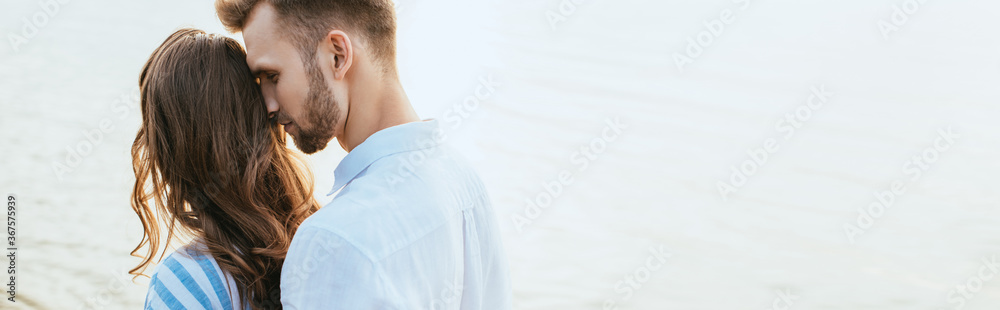 website header of bearded man hugging girlfriend near lake website header of bearded man hugging girlfriend near lake