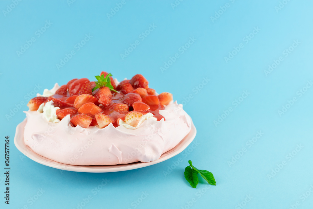 Strawberry Pavlova cake on a blue background. Copy space. Strawberry Pavlova cake on a blue background. Copy space.