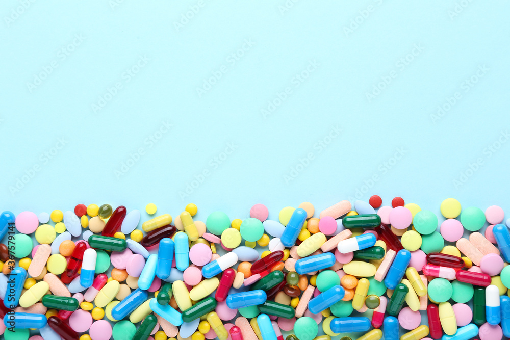 Colorful pills on blue background Colorful pills on blue background