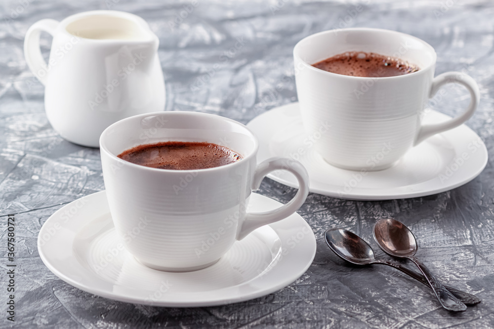 Freshly brewed aromatic coffee with cream on a gray background Freshly brewed aromatic coffee with cream on a gray background