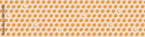 Biscuits stuffed with cream on a bright yellow background  a recurring seamless pattern  sweet background  wallpaper. Copy space  banner. top view