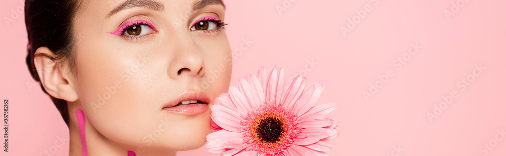 Fototapeta premium beautiful woman with pink lines on body and chrysanthemum isolated on pink, panoramic shot