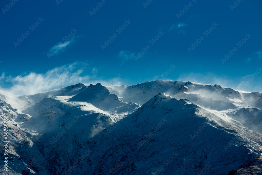 Naklejka premium Winter landscape of snow mountain against blue sky in South island, New Zealand.