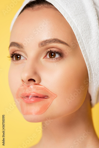 beautiful woman with towel on head, lip patch isolated on yellow