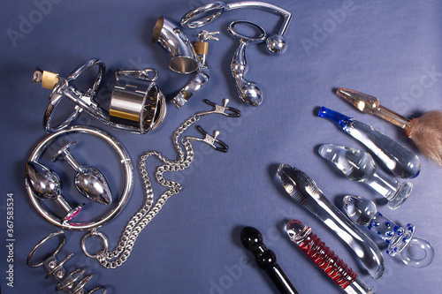 Foto the Iron sex toys on a blue background, BDSM