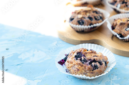 Homemade blueberry muffins on wooden board. light from the window