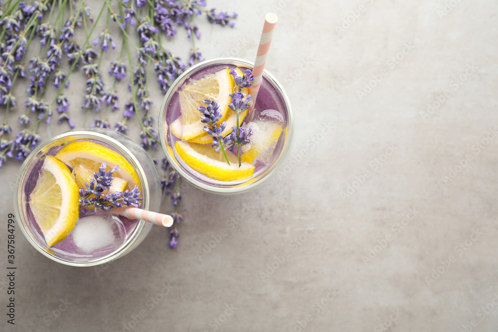 Fresh delicious lemonade with lavender on grey table, flat lay. Space for text - obrazy, fototapety, plakaty 