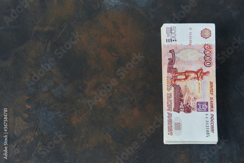 Russian rubles. A stack of five thousandth bills on a dark background. Place for text. High quality photo