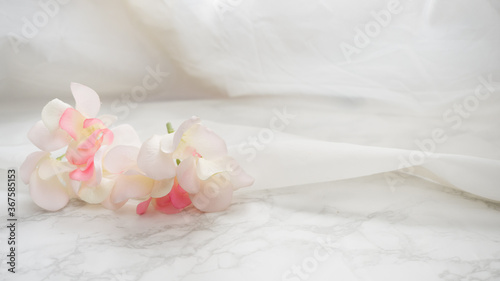 Flowers on white cloth close up