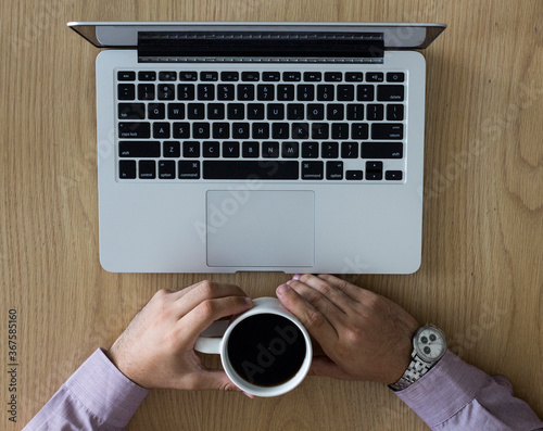 Young boy with a notebook and a cup of coffee