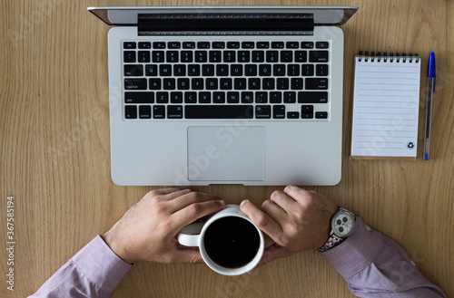 Young boy with a notebook and a cup of coffee