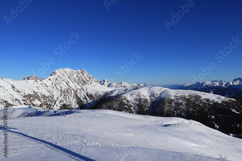 Panorama of Gaital alps with the highest mountain Eggenkofel on the left. Blue sky with ideal snow condition means perfect ski slope and enjoying the view. Ski resort Obertilliach photo