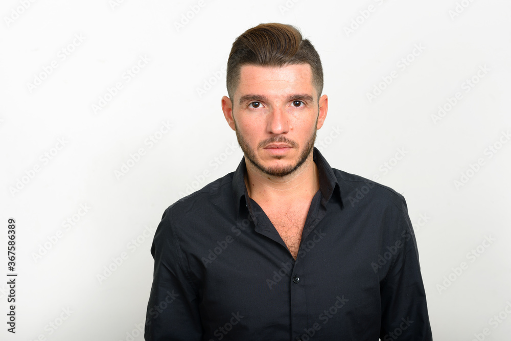 Studio shot of handsome bearded Hispanic businessman Studio shot of handsome bearded Hispanic businessman