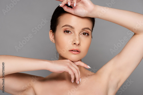 beautiful naked woman with perfect skin posing isolated on grey