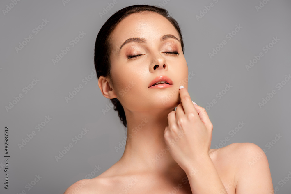 beautiful naked woman with perfect skin and closed eyes touching face isolated on grey beautiful naked woman with perfect skin and closed eyes touching face isolated on grey