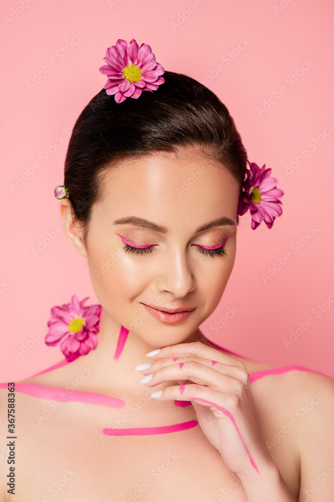 naked beautiful woman with closed eyes, pink lines on body and flowers in hair isolated on pink naked beautiful woman with closed eyes, pink lines on body and flowers in hair isolated on pink