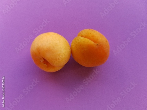 Apricots on a purple background