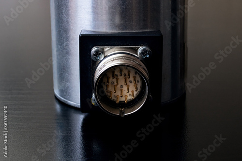 Metal encoder on a black wooden table photo