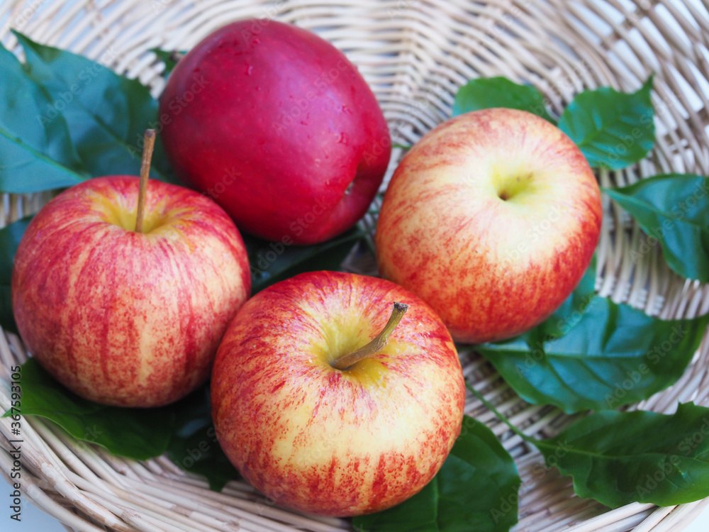 healthy food with apples red fruit in bamboo baskets and green leaves healthy food with apples red fruit in bamboo baskets and green leaves