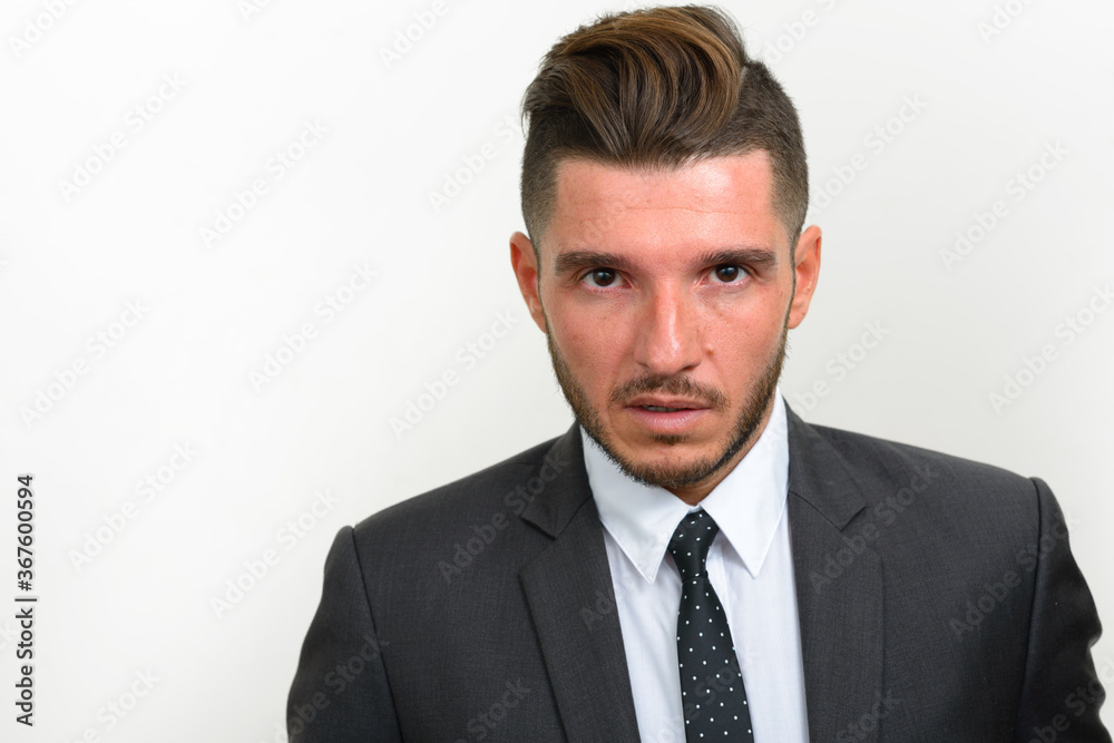 Portrait of handsome bearded Hispanic businessman in suit Portrait of handsome bearded Hispanic businessman in suit
