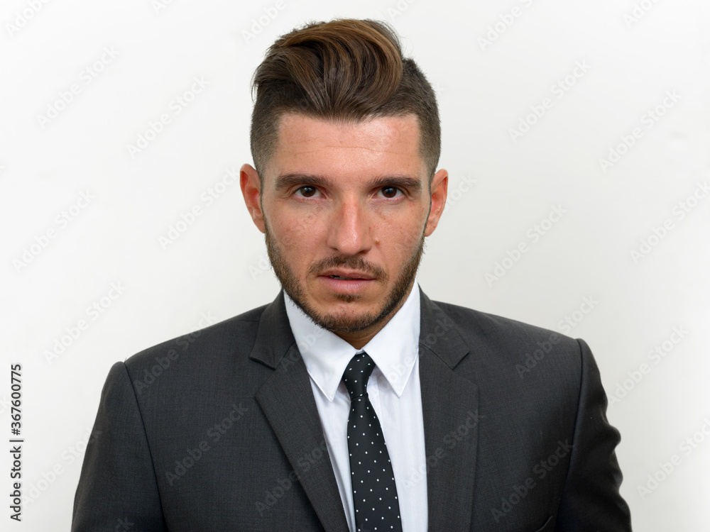 Portrait of handsome bearded Hispanic businessman in suit Portrait of handsome bearded Hispanic businessman in suit