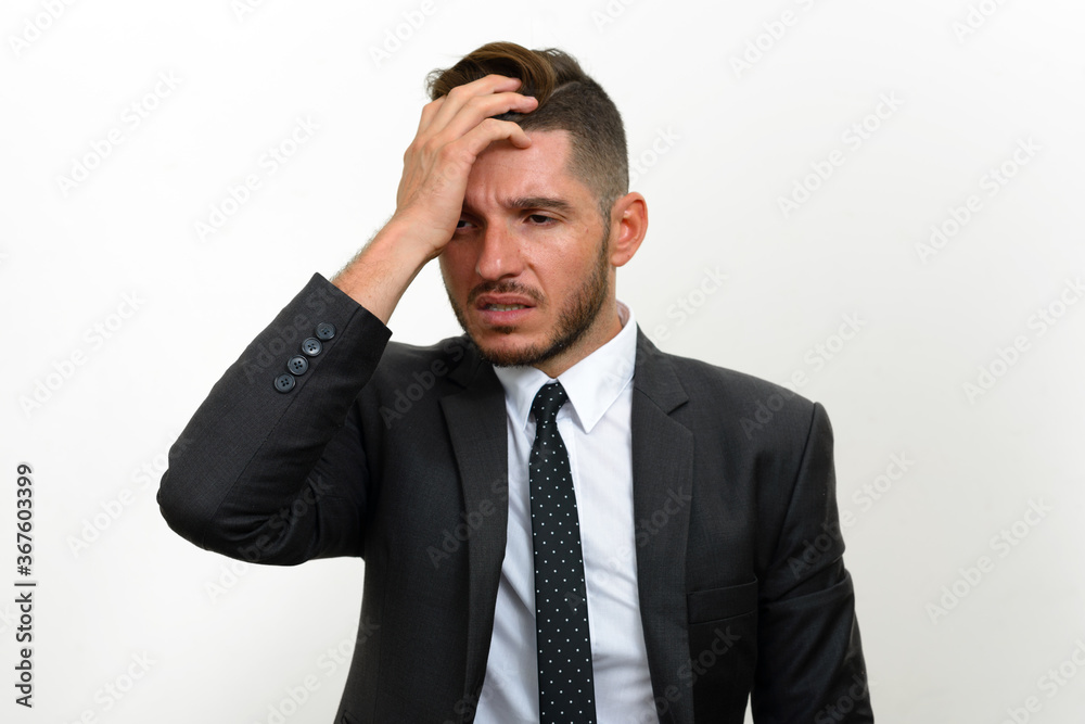 Portrait of handsome bearded Hispanic businessman in suit Portrait of handsome bearded Hispanic businessman in suit